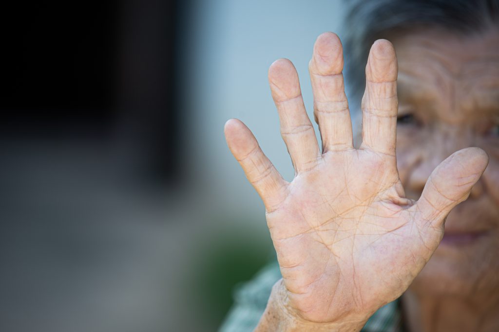 close up picture old woman s hand showing anti symbol